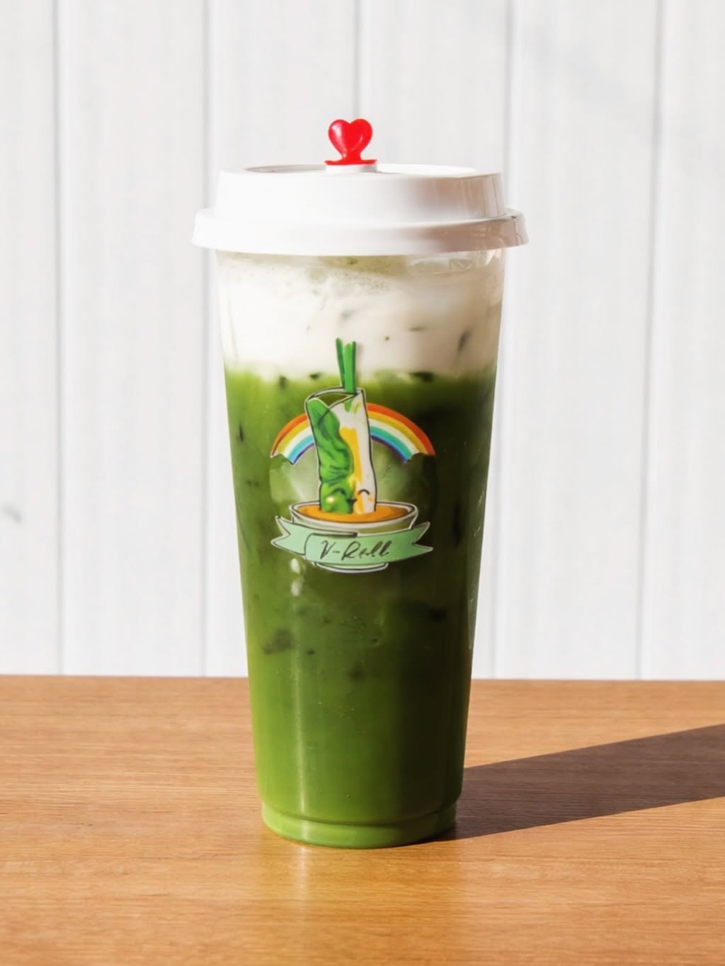 A green matcha milk tea in a V-Roll cup