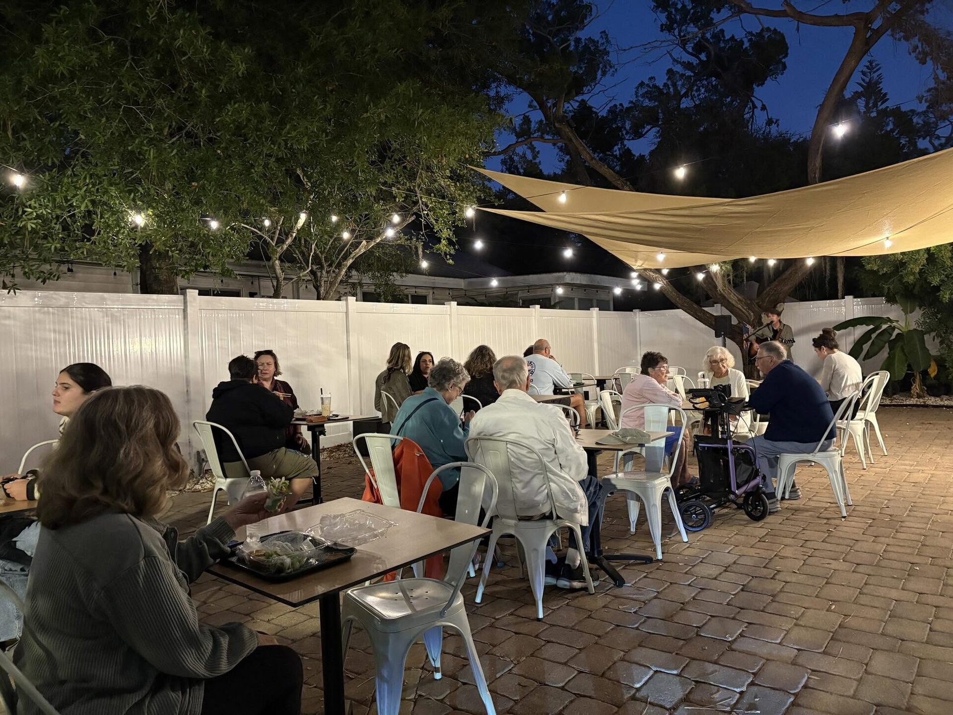 The V-Roll patio at dusk under the shade sail