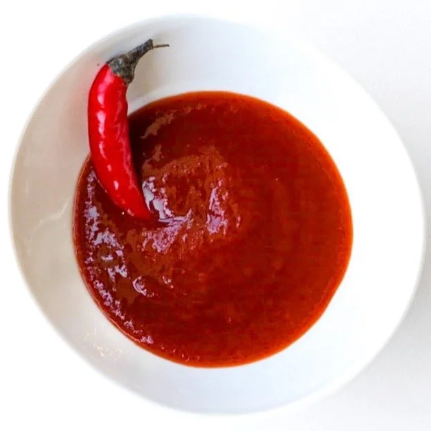 Sriracha, from above in a white dish